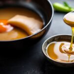 Assortment of flavorful fats: olive oil, butter, bacon fat, coconut oil, herbs, wooden spoons