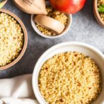 Golden Quinoa bowl with colorful vegetables and a small trophy symbolizing grain battle victory